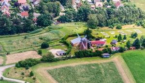 an aerial view of a house with a windmill on a hill at Holländer Mühle Rheinsberg in Rheinsberg