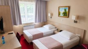 a hotel room with two beds and a television at Hotel Relaks in Wola Ducka +51 photos