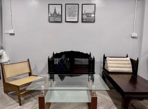 a living room with a glass table and two chairs at Soulstay Bangkok in Bangkok +19 photos