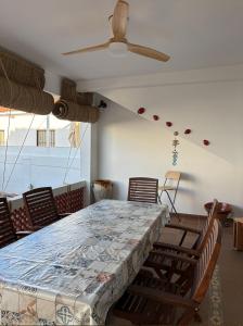 a dining room with a large table and chairs at El Chalet in Punta Umbría