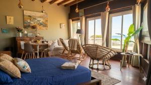a bedroom with a bed and a table and chairs at Beach apartment - Ocean sunset full view in Meschers-sur-Gironde