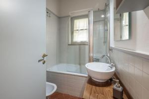 a bathroom with a tub and a sink and a toilet at Aiuola133 in Cetona +21 photos