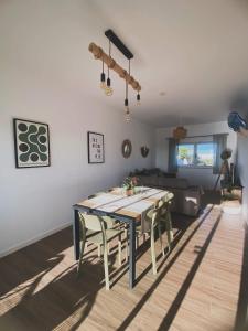 a living room with a table and a couch at Casa Biota in Sagres