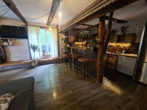 a kitchen with a bar and stools in a room at Хатка у долині in Kosiv +18 photos