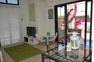 a living room with a glass table and a television at Villa Carmen- Lanzarote in Playa Blanca