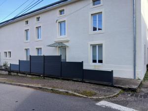 a fence in front of a white building at La grande escapade in Xertigny +4 photos
