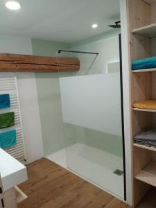 a glass walk in shower in a bathroom at La grande escapade in Xertigny