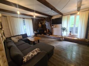 a living room with a couch and a table at Хатка у долині in Kosiv