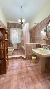 a large bathroom with a tub and a sink at La Casa al Sole in Mazara del Vallo
