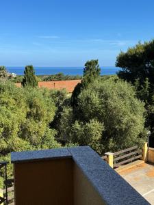 a view of the ocean from the balcony of a house at Carpa House in Valledoria