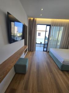 a bedroom with a bed and a large mirror at Rei Hotel in Borsh