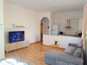a living room with a couch and a tv at Horizon Isla Tabarca in El Cabo de Gata