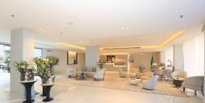 a lobby with a waiting room with chairs and tables at Bawabat Alnakhil For Hotel Apartments in Riyadh