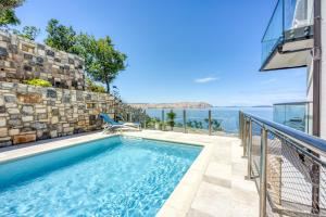 a swimming pool with a view of the ocean at 2Bfree Apartments in Stinica