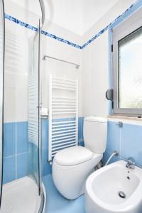 a blue and white bathroom with a toilet and a sink at Countryside Villa in Vlorë +21 photos