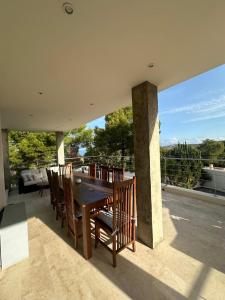 a dining room table and chairs on a patio at Wonderful Villa Cala Tarida in Sant Josep de sa Talaia