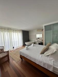 a bedroom with a large bed and a bath tub at Wonderful Villa Cala Tarida in Sant Josep de sa Talaia +18 photos