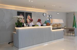 a lobby with a counter with figurines of people at Bawabat Alnakhil For Hotel Apartments in Riyadh