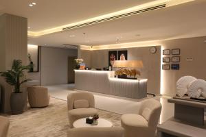 a lobby with a waiting area with chairs and a counter at Bawabat Alnakhil For Hotel Apartments in Riyadh