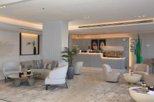 a living room with a lobby with white furniture at Bawabat Alnakhil For Hotel Apartments in Riyadh