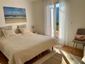 a bedroom with a bed with a view of the ocean at Villa Câline chambres d'hôtes in Vesseaux +97 photos