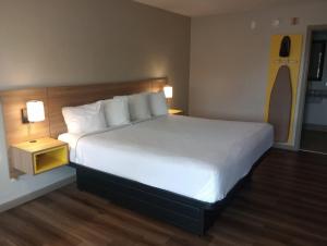 a large bed in a hotel room with two lamps at Days Inn by Wyndham Donalsonville in Donalsonville