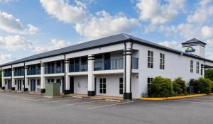 a large white building with a clock tower on top at Days Inn by Wyndham Donalsonville in Donalsonville