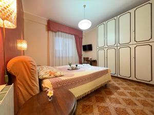 a bedroom with a bed and a table in it at La Casa al Sole in Mazara del Vallo