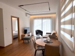 a living room with a couch and a table at Azzurro Vista in Budva