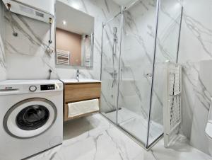a bathroom with a washing machine and a shower at Azzurro Vista in Budva +53 photos
