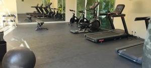 a gym with a bunch of exercise bikes and treadmills at Akumalito Santamar in Akumal