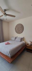 a bedroom with a bed and a ceiling fan at Akumalito Santamar in Akumal +22 photos