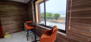 a balcony with a table and chairs and a window at Ridge Condos Hotel - Phase Three in Kumasi +30 photos