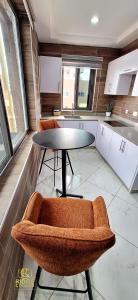 a kitchen with a table and chairs in a room at Ridge Condos Hotel - Phase Three in Kumasi