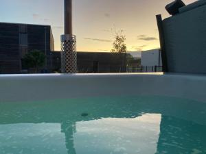 a pool of water with a view of a building at L'Atelier du Champ Ladoit in Mercurey