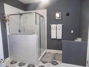 a bathroom with a walk in shower and a sink at The Lantern in Pensacola +16 photos