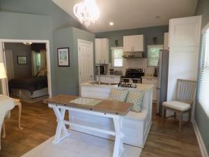 a kitchen and living room with a table and a couch at The Lantern in Pensacola