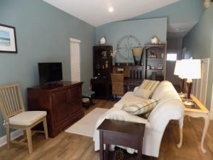 a living room with a white couch and a table at The Lantern in Pensacola
