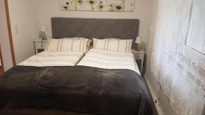 a large bed in a room with a window at Ferienwohnung Auszeit in Hohnstein
