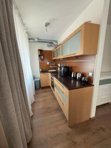 a kitchen with wooden cabinets and a counter top at Stay in Old Town in Võru
