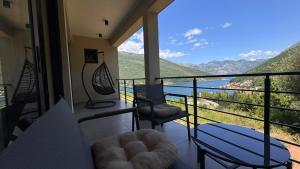 a balcony with chairs and a view of the mountains at Polaris Astra Bay in Lepetani