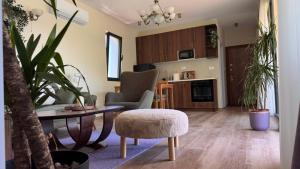 a living room with a table and a chair at Polaris Astra Bay in Lepetani
