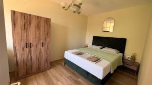 a bedroom with a bed and a large wooden door at Polaris Astra Bay in Lepetani
