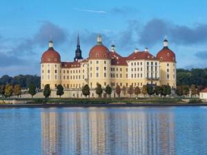 a large building with red domes on top of the water at Am Rittergut Giesenstein Gartenblick in Bad Gottleuba