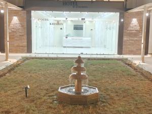 a museum with a fountain in the middle of a room at Hotel Krishiv- Sanand in Sānand