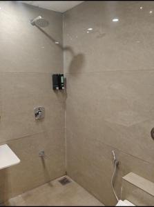 a shower with a glass door in a bathroom at Hotel Krishiv- Sanand in Sānand +8 photos