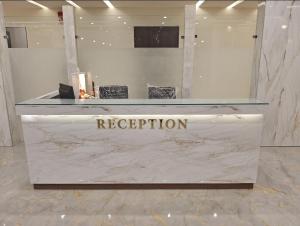 a reception area in a store with a marble counter at Hotel Krishiv- Sanand in Sānand