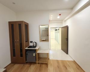 a kitchen with a counter and a sink in a room at Hotel Krishiv- Sanand in Sānand