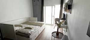 a bedroom with a bed and a table and a window at ROOM 335 in São Martinho do Porto +22 photos