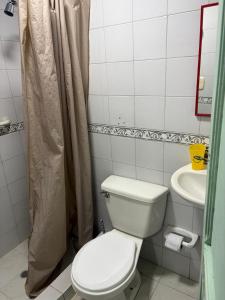 a bathroom with a toilet and a sink at Playa Zen Rodadero in Rodadero